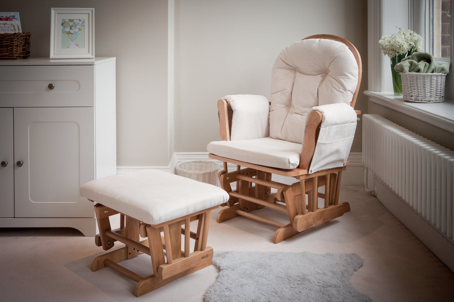 Natural wood Haywood glider chair  and footstool with beige cushions in a room